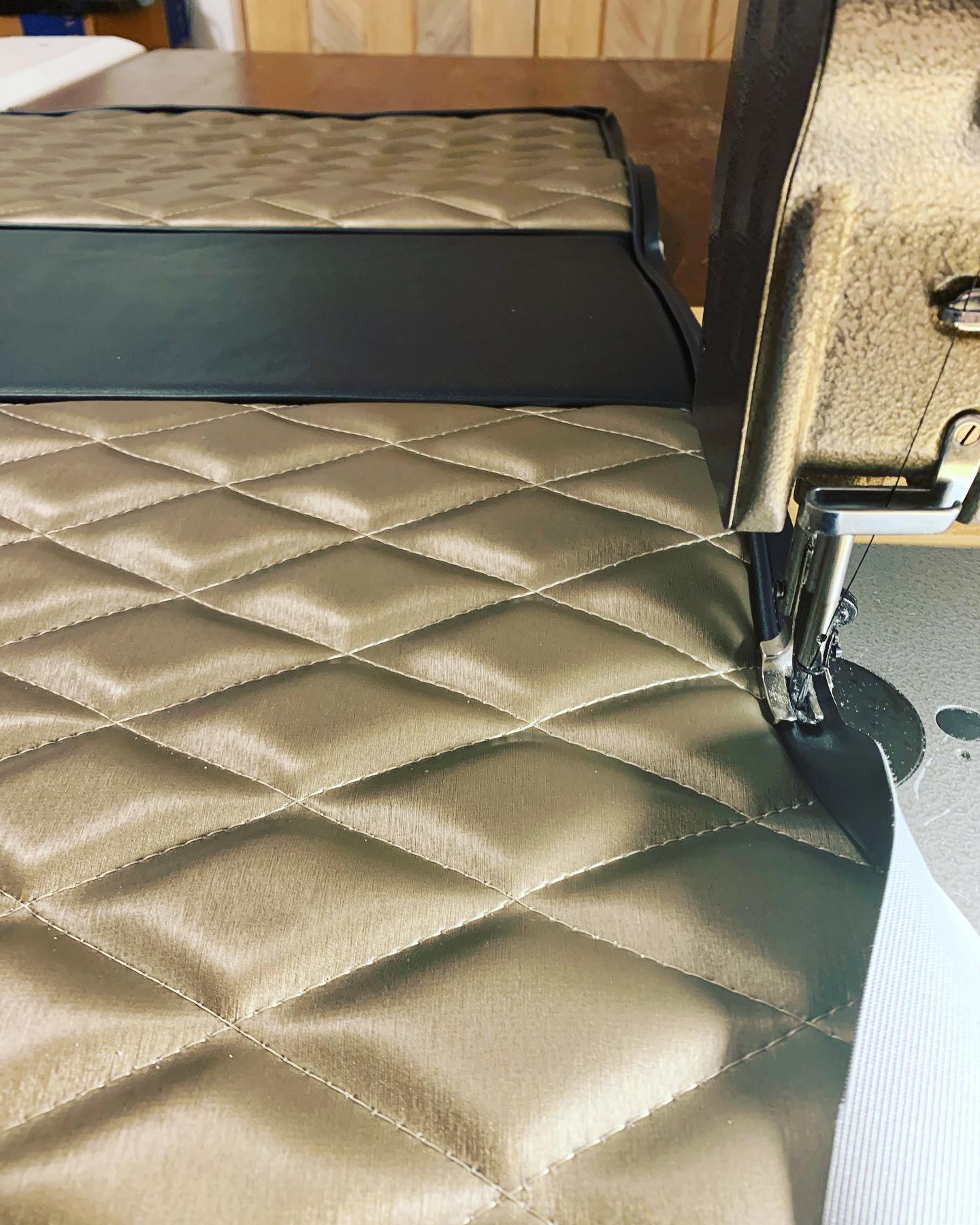 Diamond-stitched automotive upholstery panel in metallic vinyl being sewn at B62 Upholstery.